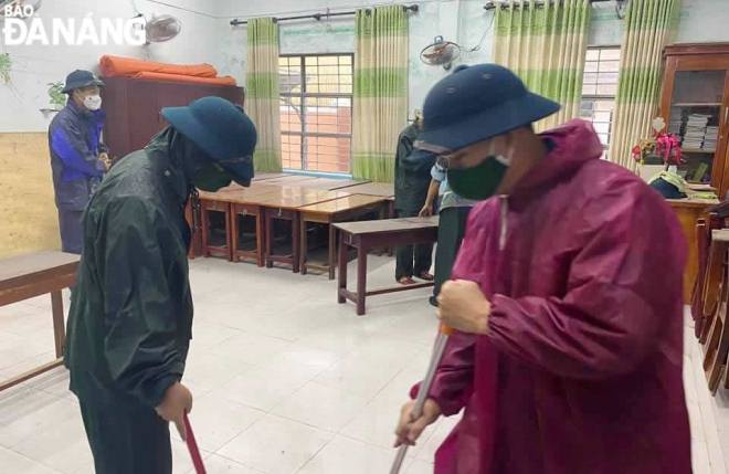 Military personnel cleaning a school to provide a temporary safe shelter for the evacuated people in Lien Chieu District before the storm hits land.