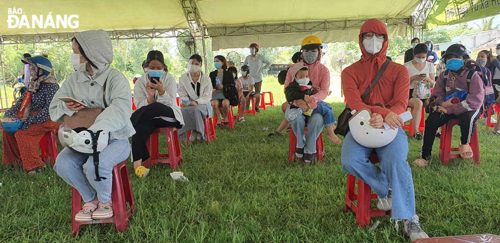  Pupils and their companions wait for the sampling for SARS-CoV-2 testing at a checkpoint on National Highway 14B, Hoa Khuong Commune, Hoa Vang District.