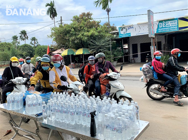 Người dân các tỉnh phía Nam về quê qua địa phận thành phố Đà Nẵng nhận nước uống, thức ăn miễn phí. Ảnh: L.P
