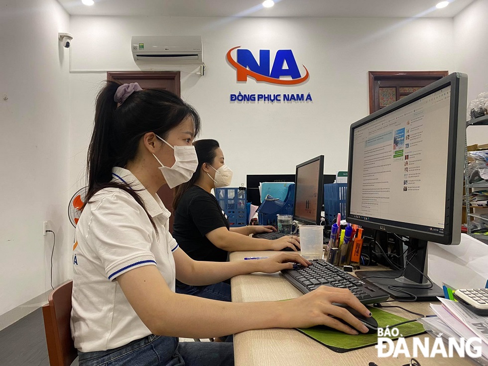 Employees of enterprises who receive at least one dose of a COVID 19 vaccine can return to workplace. Photo is taken at the Nam A (South Asia) Uniform Company by XUAN SON.