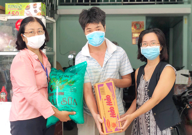 Chị Võ Thị Thanh (bìa trái) hỗ trợ một học sinh có hoàn cảnh khó khăn trên địa bàn. (Ảnh nhân vật cung cấp)