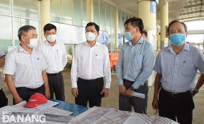 Da Nang People’s Committee Vice Chairman Tran Phuoc Son (centre) listening to reports about the upgrade and expansion of the Tho Quang Fishing Wharf and Port 