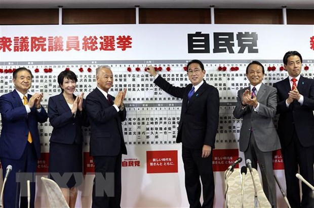 Thủ tướng Nhật Bản, Chủ tịch LDP Fumio Kishida gắn hoa bên cạnh tên của những ứng cử viên trúng cử trong cuộc bầu cử Hạ viện tại Tokyo ngày 31/10/2021. (Ảnh: AFP/TTXVN)