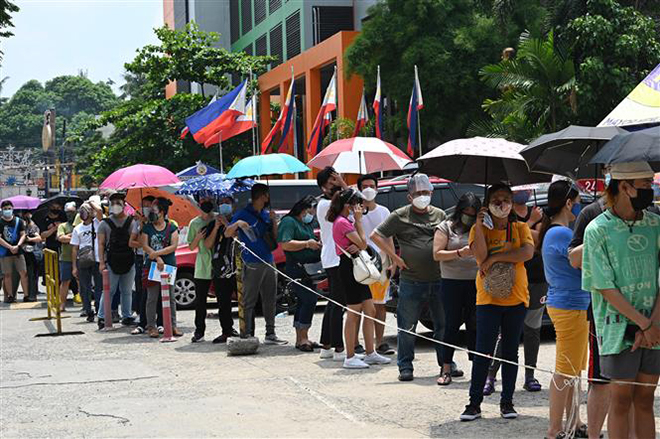 Người dân xếp hàng chờ tiêm vaccine ngừa Covid-19 tại Thành phố Mandaluyong, ngoại ô Manila, Philippines. Ảnh: AFP/TTXVN