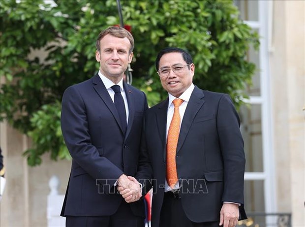 Prime Minister Pham Minh Chinh (R) and French President Emmanuel Macron (Photo: VNA) 