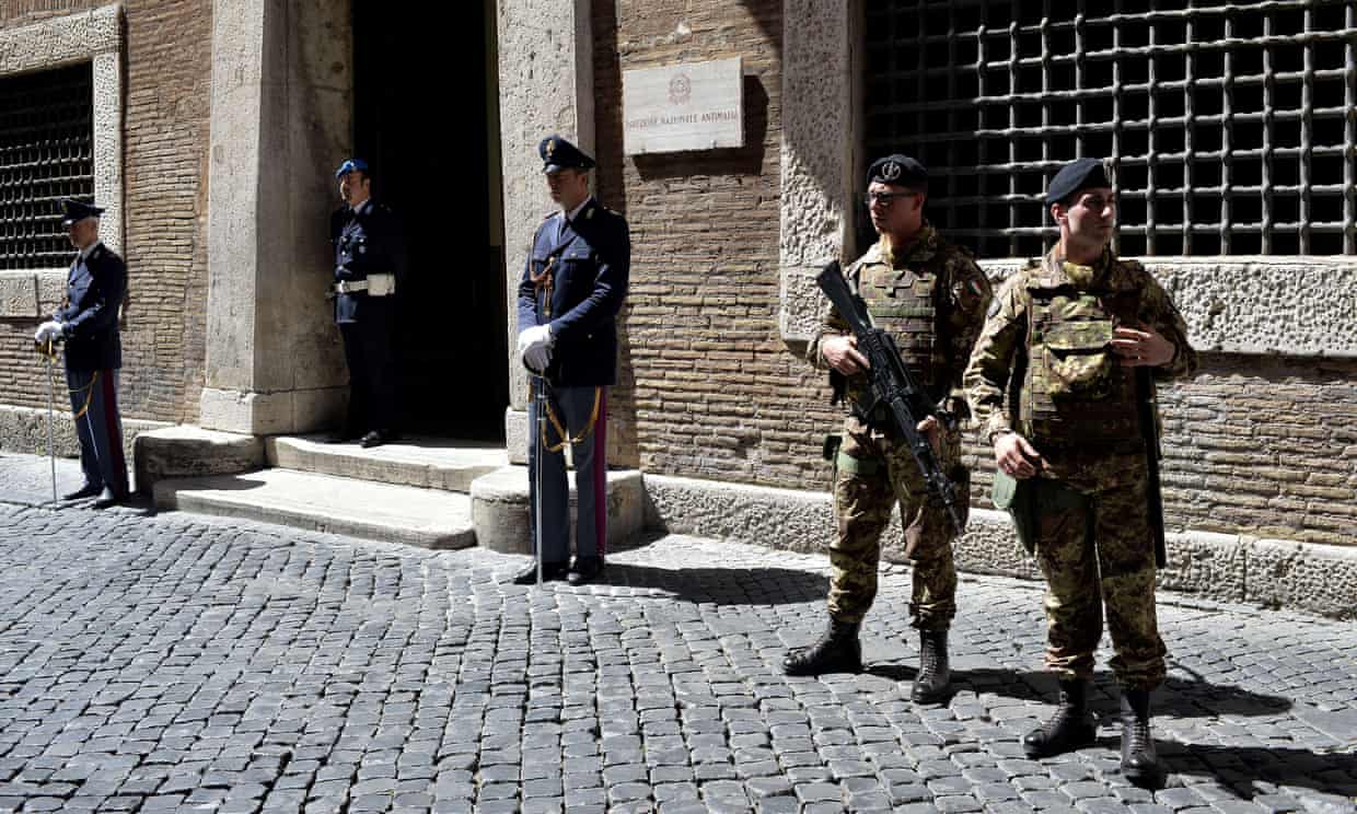 Các sĩ quan cảnh sát và binh sĩ đứng gác bên ngoài trụ sở dịch vụ chống mafia quốc gia Italy ở Rome. Ảnh: AFP