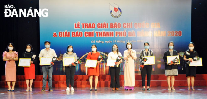 Phó Bí thư Đảng ủy Khối các Cơ quan thành phố Nguyễn Thị Kim Hoa và Phó Giám đốc Sở Thông tin và Truyên thông Nguyễn Thị Thu Phương trao giải cho các tác giả, nhóm tác giả đoạt giải 3 giải Báo chí thành phố năm 2020. Ảnh: LÊ HÙNG