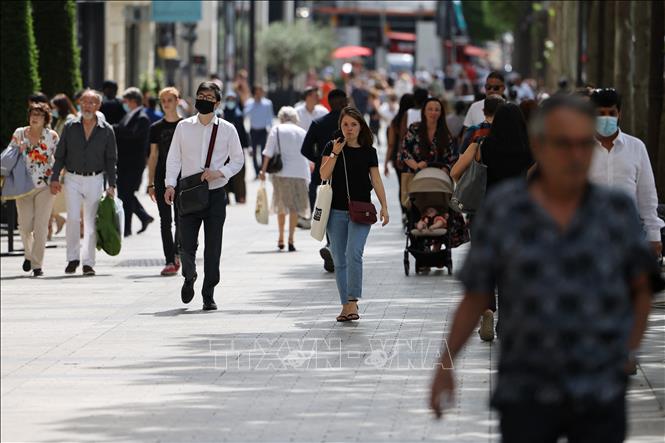 gười dân di chuyển trên phố ở Paris, Pháp ngày 17/6/2021. Ảnh: AFP/TTXVN