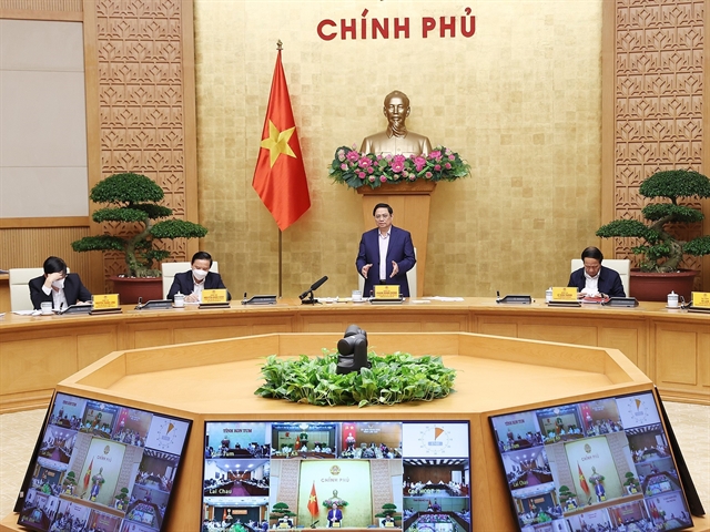 Prime Minister Phạm Minh Chính (standing) chairs the national conference with local governments on COVID-19 on Saturday. — VNA/VNS Photo Dương Giang