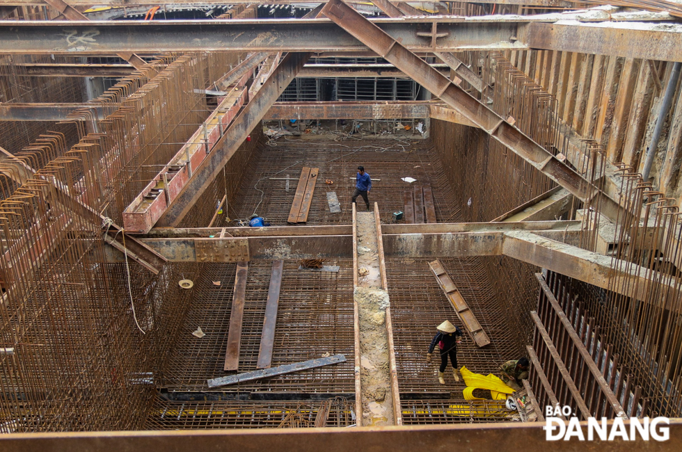 The tunnel is built by excavating from the surface, constructing the structure, and then covering with backfill.