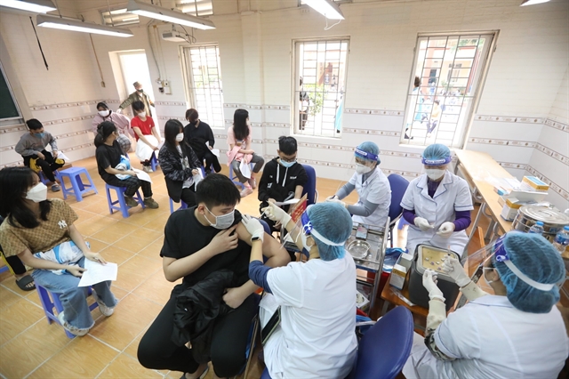Nine grade students at Nguyễn Trãi Secondary School in Hà Nội's Hà Đông District are given COVID-19 vaccinations on Saturday. —VNA/VNS Photo Minh Quyết