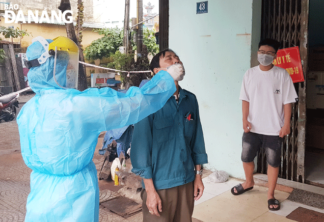 Da Nang is ready to step up to treat COVID-19 patients at home and healthcare workers at local level will play important role in the success of the city’s pilot scheme. IN THE PHOTO: A healthcare professional in An Hai Bac Ward in Son Tra District taking nasal swab sample of a primary close contact that is self- isolating at home for COVID-19 testing. Photo: PHAN CHUNG