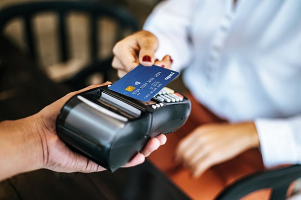 A customer uses a chip card for payment at a point-of-sale (POS). VNA/VNS Photo