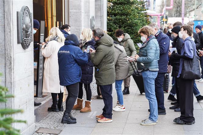 Nhân viên kiểm tra chứng nhận tiêm vaccine phòng COVID-19 của khách hàng tại trung tâm thương mại ở Berlin, Đức, ngày 3/12/2021. Ảnh: THX/ TTXVN