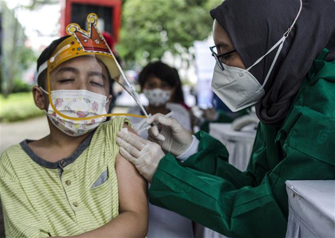  Nhân viên y tế tiêm vaccine phòng Covid-19 cho trẻ em tại Bandung, Tây Java, Indonesia, ngày 16-12-2021. Ảnh: THX/ TTXVN