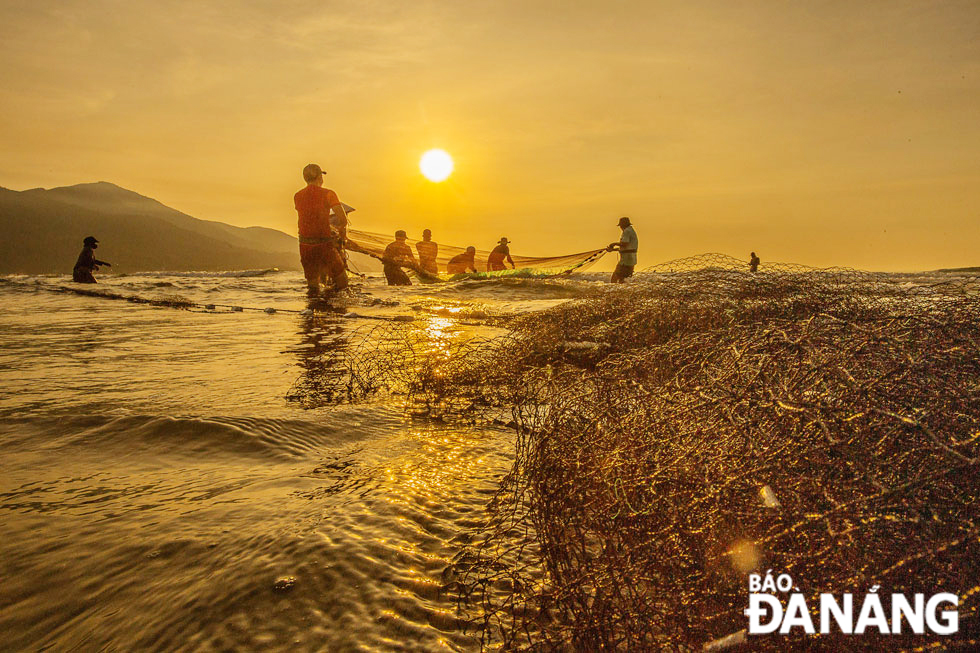 Pulling nets at Man Thai beach at dawn.