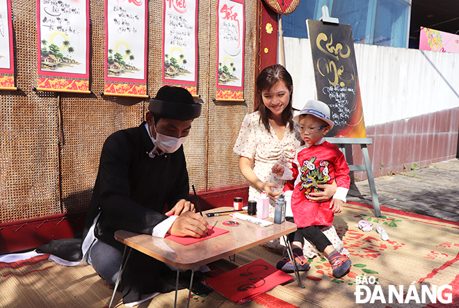 A calligrapher doing calligraphy at the ongoing Tet Fair