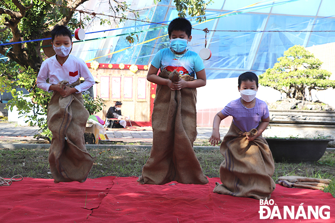 Children happily participating in the game of sack jumping