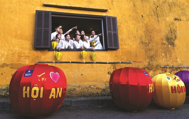 Models pose at an old house in Hội An City. The area has opened tourism services for 2022. Photo courtesy of Mai Thanh Chương 