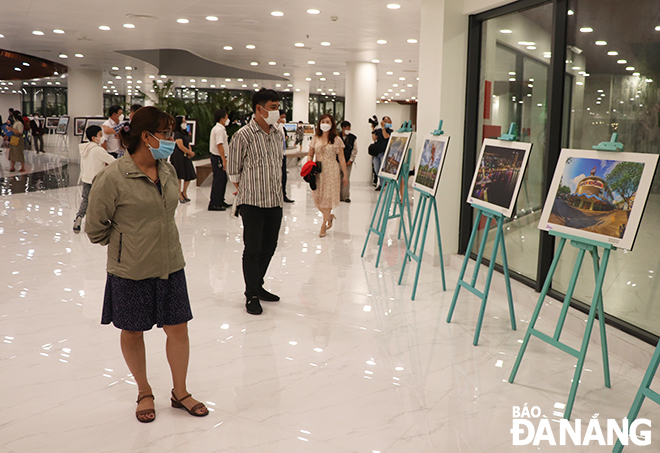 Visitors are seen at the exhibition on Saturday evening