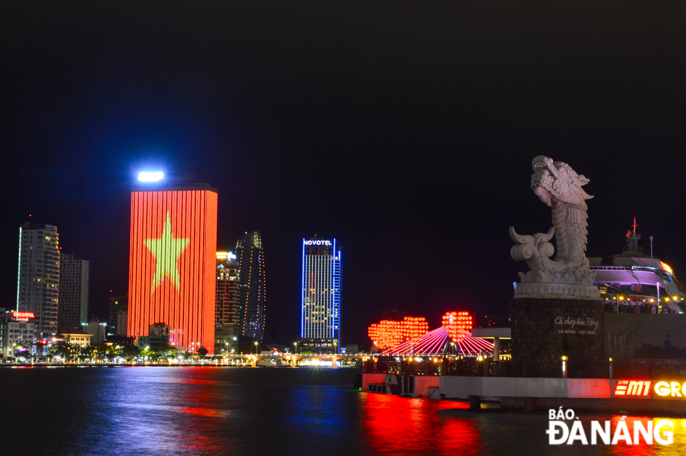 A corner of the city on Lunar New Year's Eve with buildings and bridges lit up with shimmering lights.