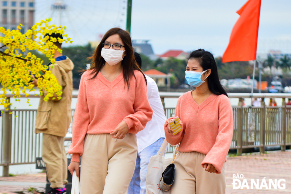 People are seen wearing face masks in public venues and only take off their face masks when taking photos.