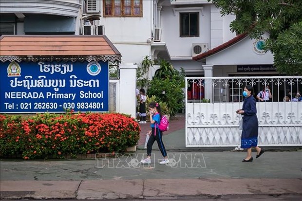 Laos reduces quarantine period for visitors to 7 days. (Photo: AFP/VNA)