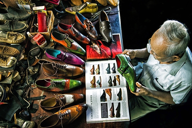 The winning photo showing Trịnh Ngọc, a 90-year-old shoemaker taken by Vietnamese photographer Trần Việt Văn. — Photo courtesy of TPOTY