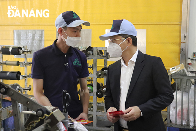 Bí thư Thành ủy Nguyễn Văn Quảng thăm hỏi, động viên và lì xì đầu năm mới đối với người lao động đang làm việc tại Công ty TNHH Apple Filim Đà Nẵng vào sáng 8-2. Ảnh: K.HÒA