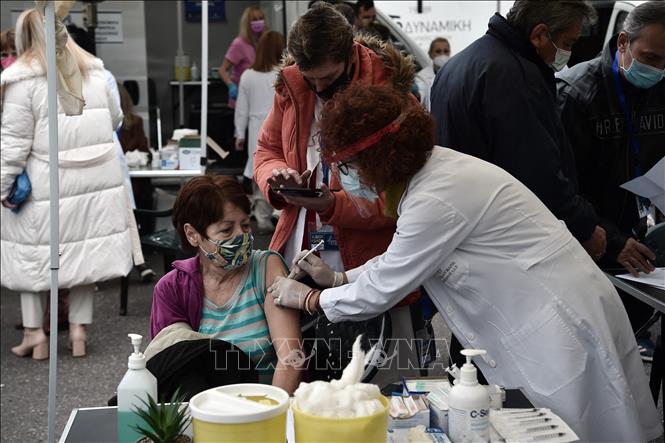 Nhân viên y tế tiêm vaccine phòng COVID-19 cho người dân tại Thessaloniki, Hy Lạp, ngày 26/11/2021. Ảnh: AFP/TTXVN