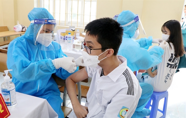 Students receive COVID-19 vaccine shots at a high school in the northern province of Phú Thọ in late November 2021. — VNA/VNS Photo Trung Kiên