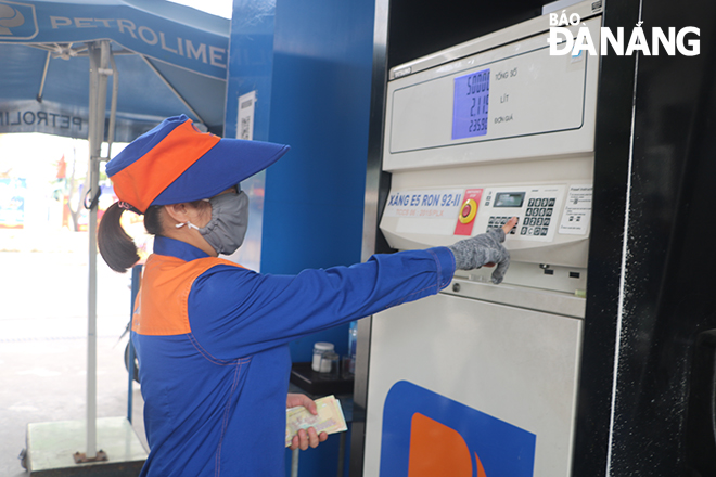 A staff is seen working at a petrol and oil store on September 2 Street on February 10. Photo: VAN HOANG