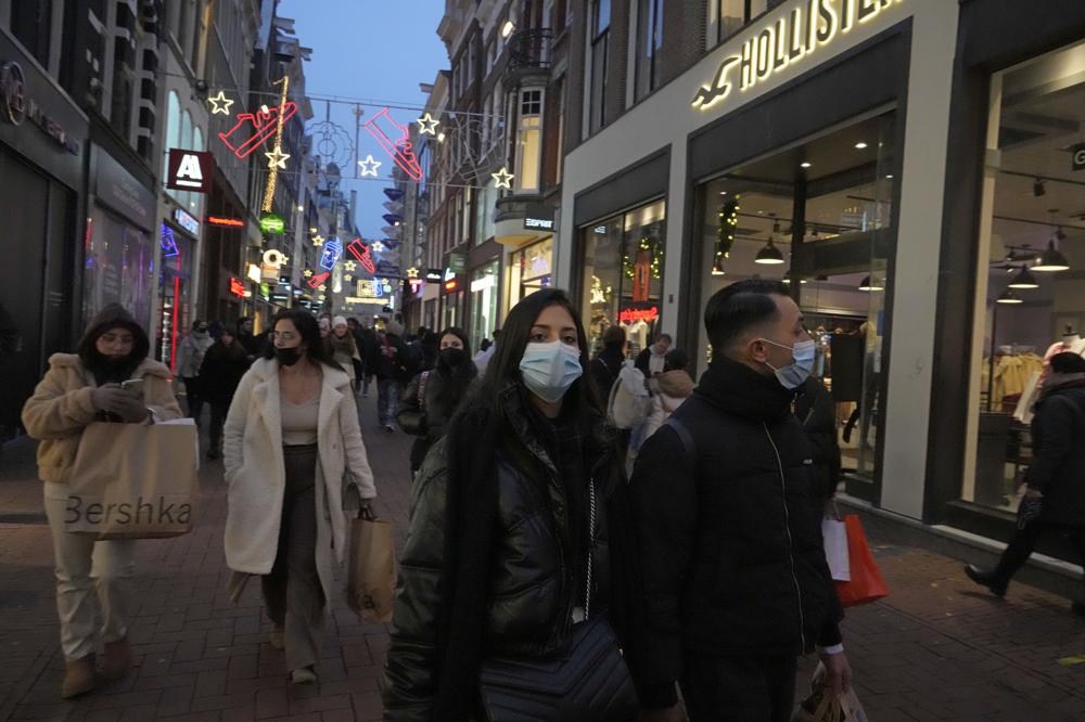 Người dân đeo khẩu trang khi di chuyển trên đường phố Amsterdam (Hà Lan). Ảnh: AP