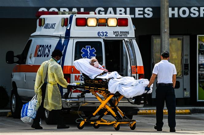 hân viên y tế chuyển bệnh nhân COVID-19 tới bệnh viện ở Coral Gables, gần Miami, Mỹ. Ảnh: AFP/ TTXVN
