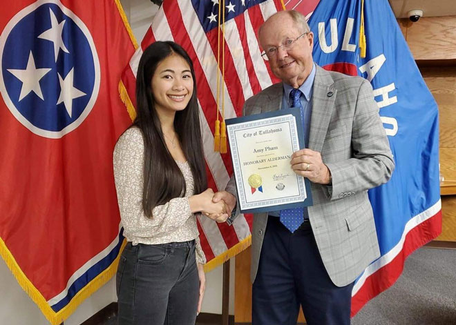 The mayor of Tullahoma presents a certificate of merit to Amy Pham for her outstanding achievements. (Photo courtesy by the character)