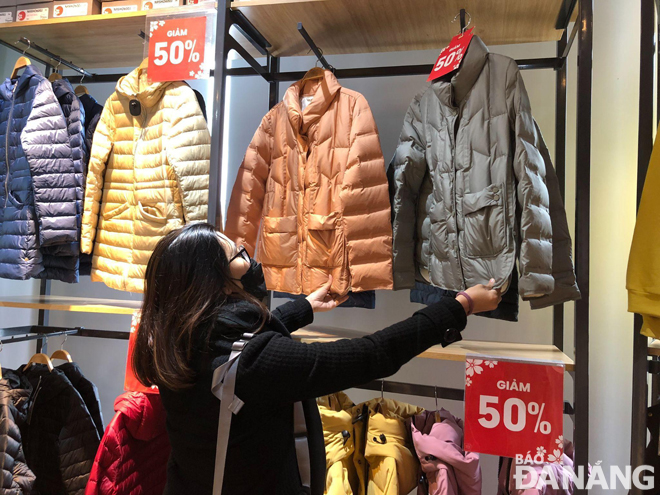 A shopper kicks up favourite warm clothes at a downtown fashion store in Da Nang. Photo: VAN KHANH