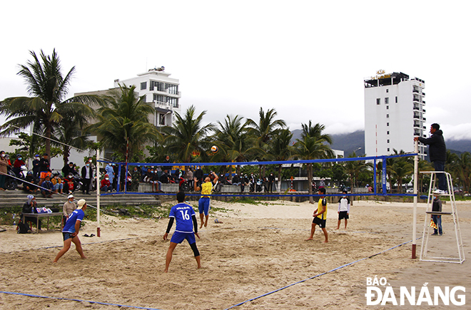A beach volleyball competition, as part of the festival, is in progress.