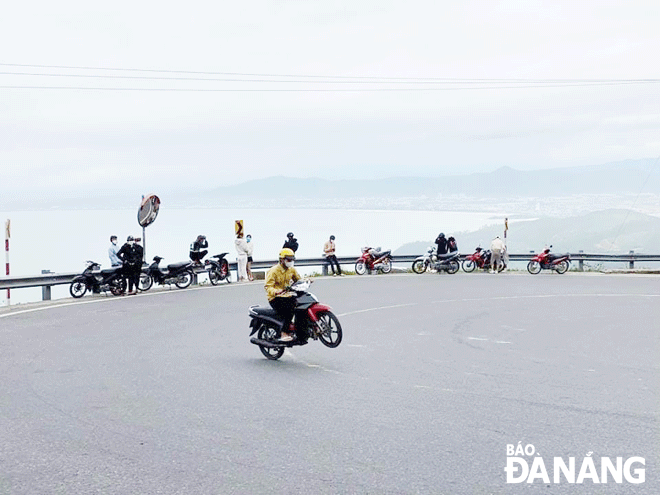 A young man does a wheelie at Hai Van Pass. Photo: P.C