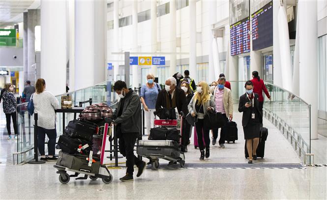 Hành khách đeo khẩu trang phòng dịch COVID-19 tại sân bay quốc tế Toronto Pearson ở Mississauga, Ontario, Canada, ngày 10/3/2022. Ảnh: THX/ TTXVN