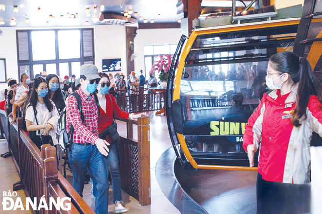 Tourists visit and have fun at the Sun World Ba Na Hills on the first day of its re-opening. Photo: THU HA