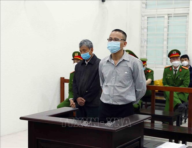 Bị cáo Lê Văn Dũng (bên phải) và bị cáo Nguyễn Văn Son tại phiên tòa xét xử. Ảnh: Phạm Kiên/TTXVN