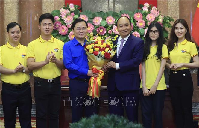 Chủ tịch nước Nguyễn Xuân Phúc tặng hoa chúc mừng đoàn viên, thanh niên nhân kỷ niệm 91 năm Ngày thành lập Đoàn. Ảnh: Thống Nhất/TTXVN