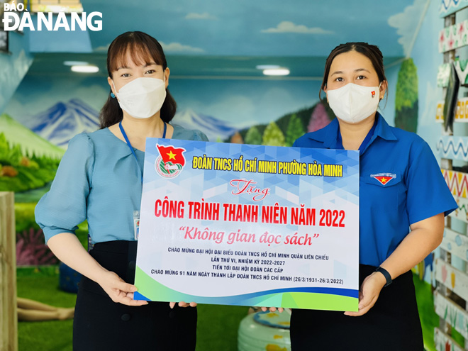 Secretary of the Hoa Minh Ward's YU organisation Ho Nguyen Thi Thuy Linh (right) handing over the ‘Reading space’ model to the Vo Thi Sau Primary School representative