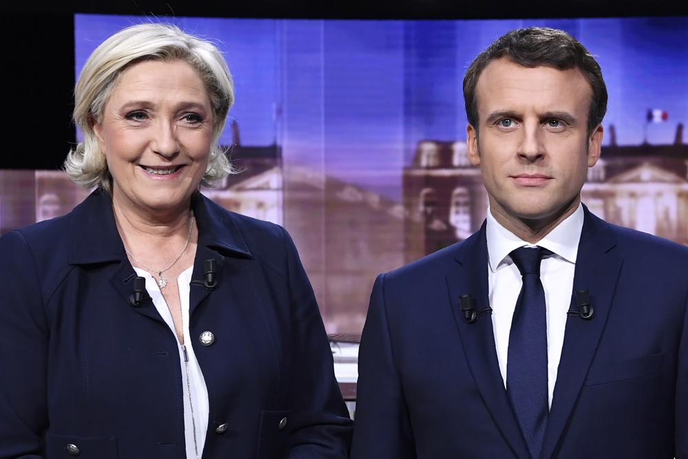 Bà Marine Le Pen (bên trái) và ông Emmanuel Macron sẽ đối mặt trong cuộc tranh luận trực tiếp trên truyền hình ngày 20-4 (giờ Pháp). Ảnh: AP