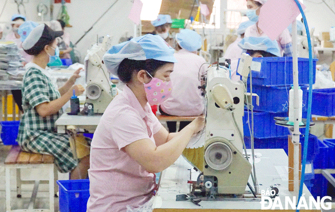 Workers are in a desperate need of a wage hike amidst the skyrocketing commodity price.  Workers are observed being on duty at the Kane-M Da Nang Co., Ltd in Hoa Khanh Industrial Park, Lien Chieu District. Photo: M.QUE