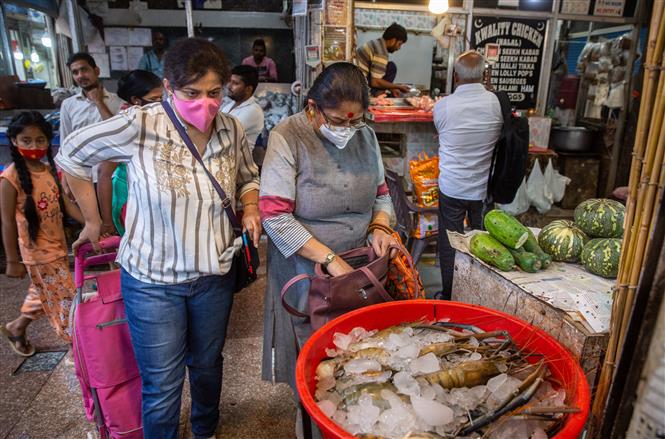 Người dân đeo khẩu trang phòng dịch COVID-19 tại một khu chợ ở New Delhi, Ấn Độ, ngày 13/4/2022. Ảnh: THX/ TTXVN