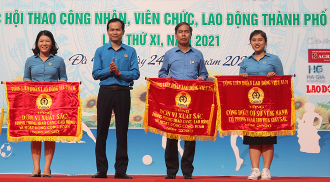 Chủ tịch Liên đoàn Lao động thành phố Nguyễn Duy Minh (thứ 2 từ trái sang) tặng cờ đơn vị xuất sắc cho các Công đoàn có thành tích nổi bật trong lễ phát động Tháng Công nhân năm 2021.