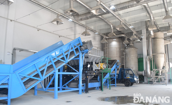 The conveyor and bulky garbage crushing system is seen operating. The crushed garbage is later loaded onto dump trucks for transportation into the garbage compaction system.