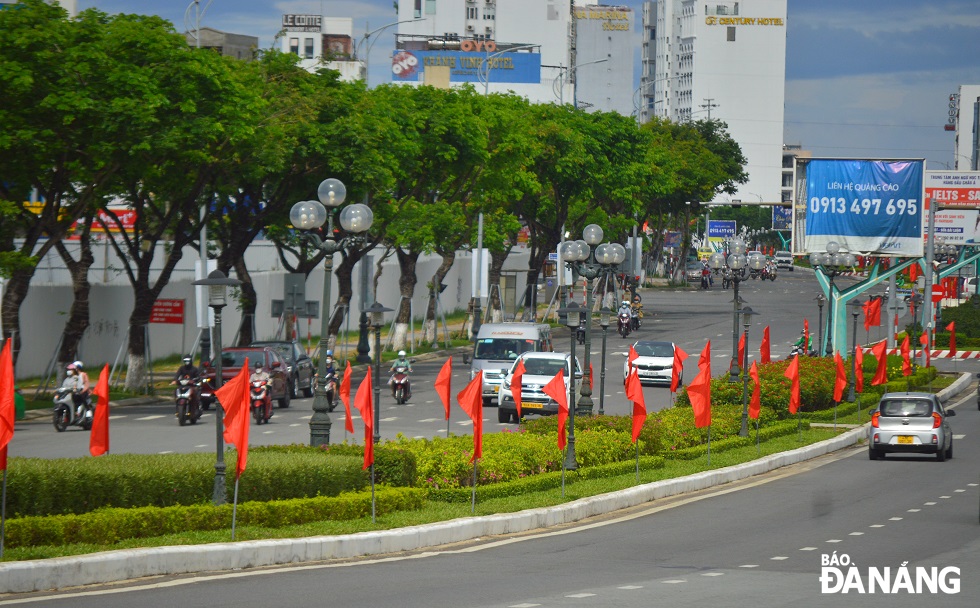 A road on the western end of the Rong (Dragon) Bridge is decorated with national flags in celebration for the National Reunification Day.