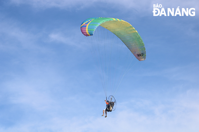  The athlete must control a paraglider with an explosive engine device weighing 20-30kg when flying in the sky. Photo: VAN HOANG